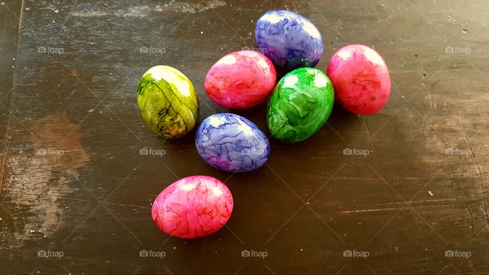 Seven Easter Eggs on a wooden table