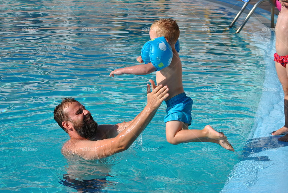 playing with daddy in swimmingpool