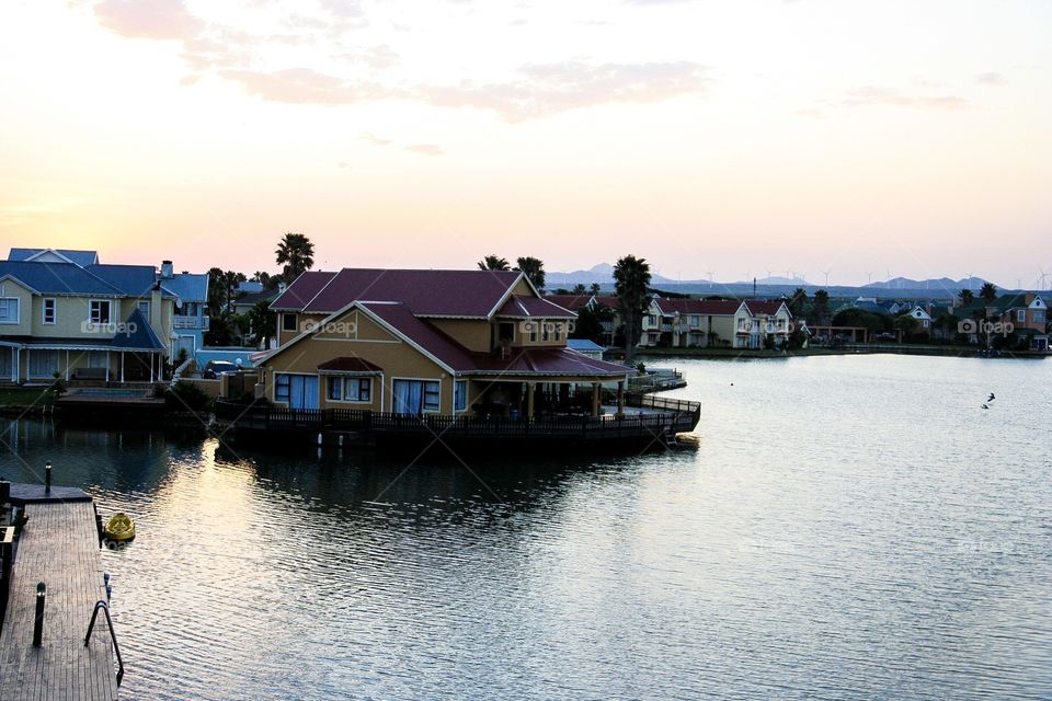 How beautiful is this sunset over the river with the moored boat at the jetty