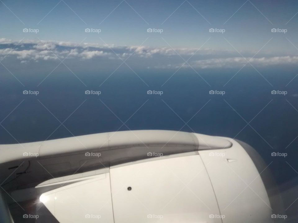 white clouds like a giant wave covering the sea, blue sky and beautiful scenery