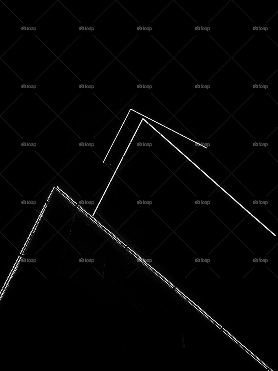 Lights on the building with triangular shaped in black and white.