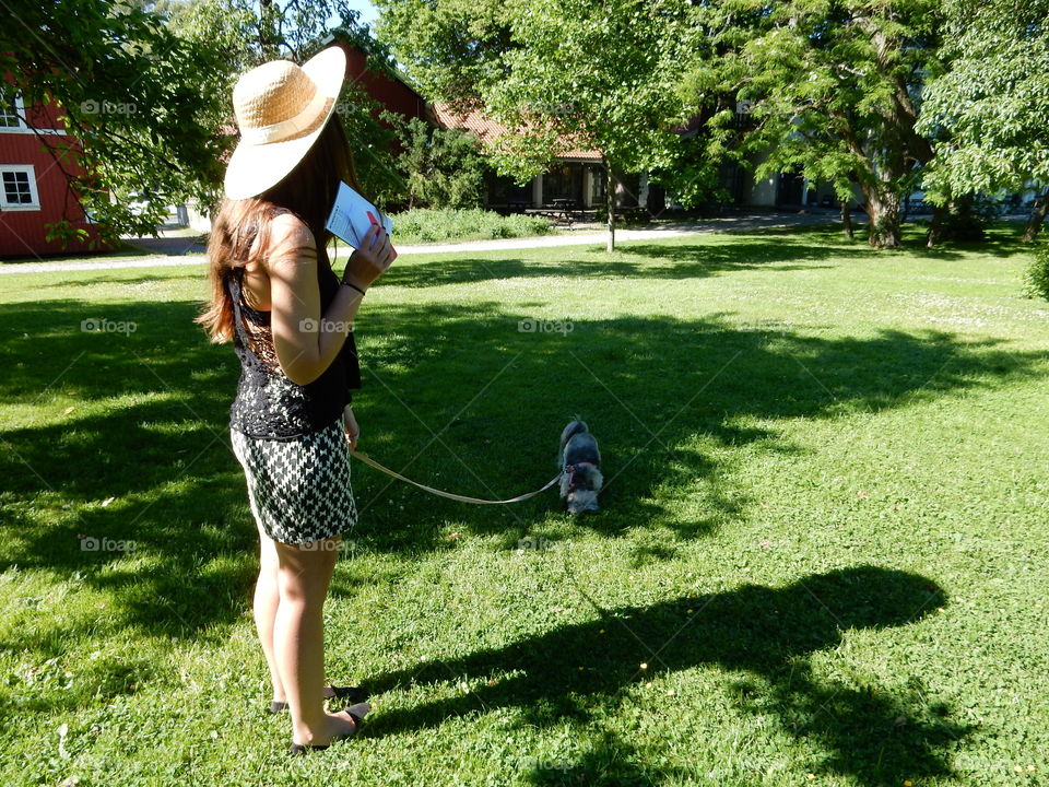 Girl and her dog. A girl and her dog walking in a park