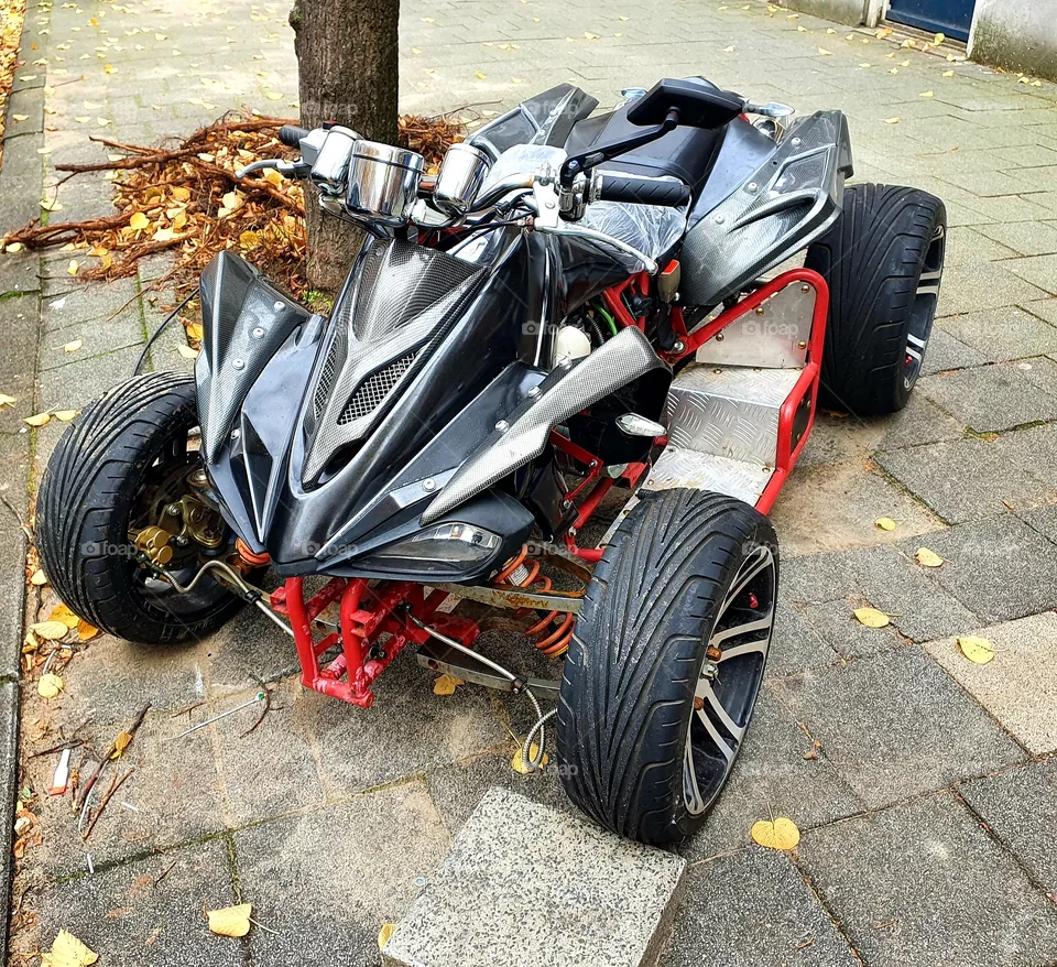 A quad, is a four-wheeled motorcycle.
