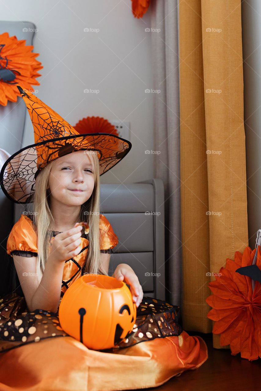 Happy kid celebrating Halloween at home 