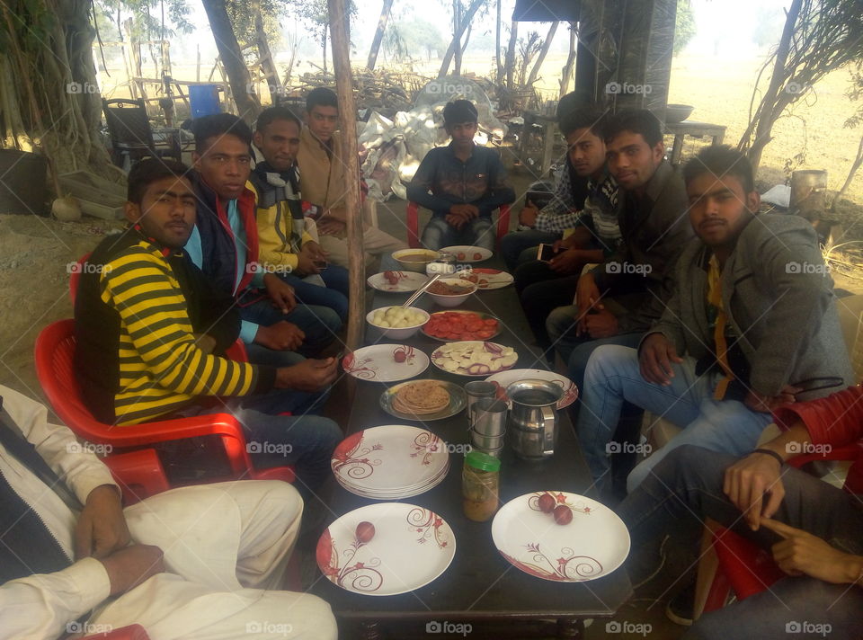 Friends eating food on table at outdoors