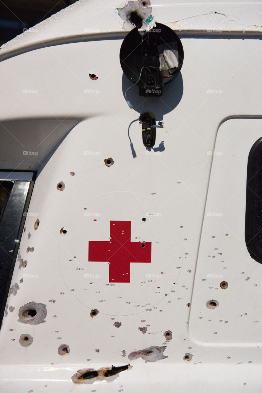 A real ambulance from the Red Cross who had been attacked in war. The Ambulance has bulletholes just everywhere and even firebombs have been thrown against it. The ambulance is part of efforts to make people aware of what happens in war. Ambulance shown up in various parts of the world. The picture is from Malmö Sweden.