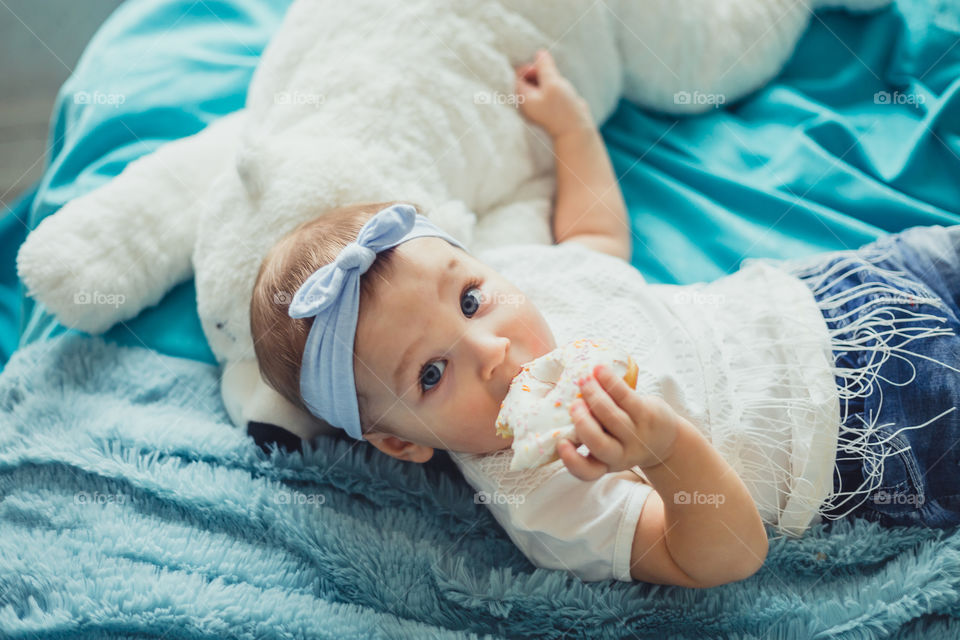 Little girl eating the donuts