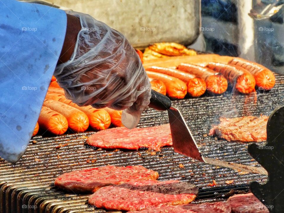 Burgers And Hot Dogs Cooking On The Grill