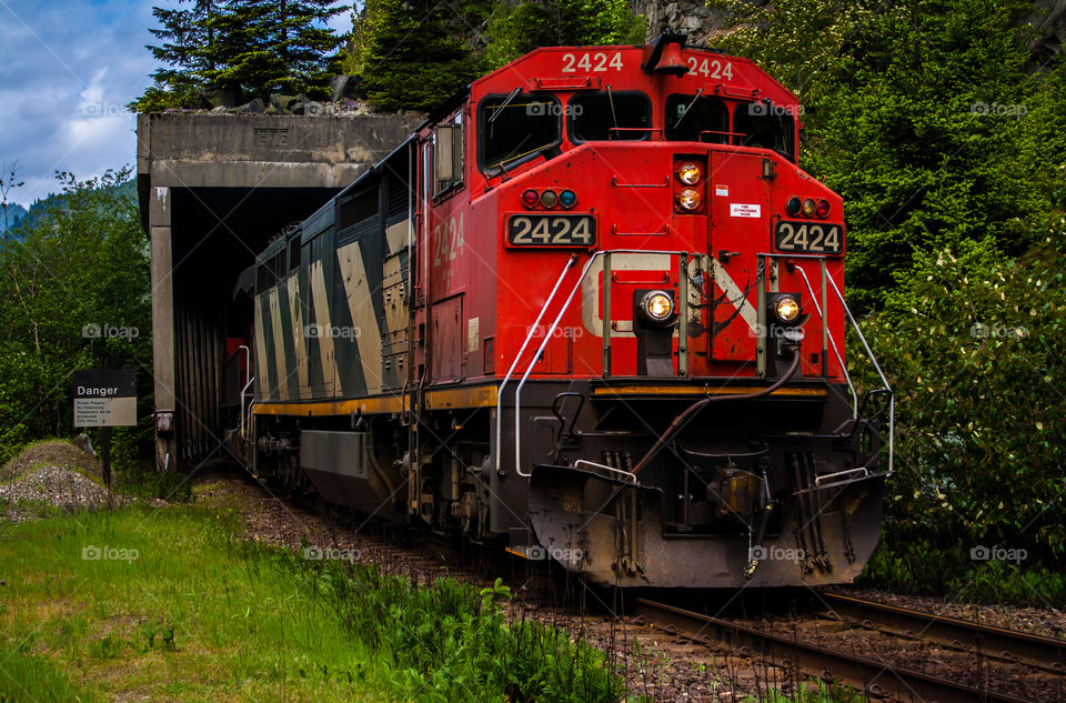 Locomotive coming out of tunnel. 