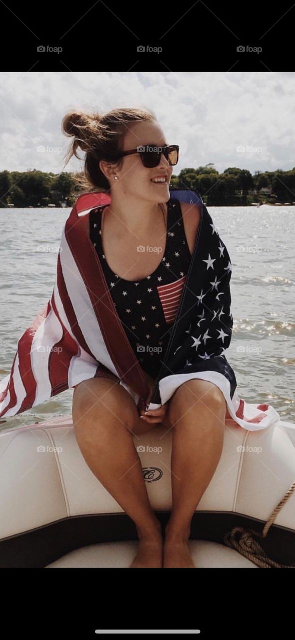 Adult woman celebrating America on the lake