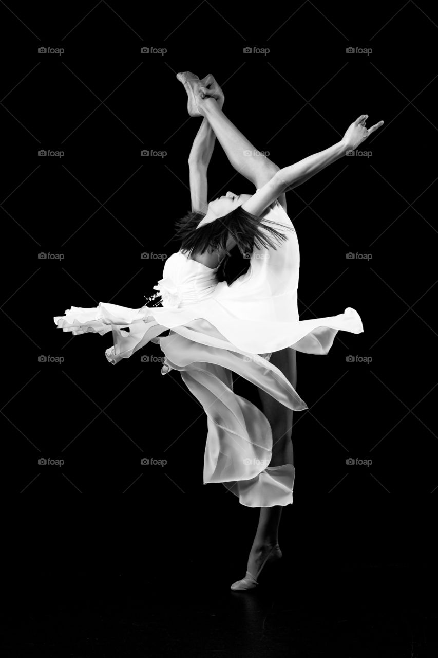Girl dancing on black background