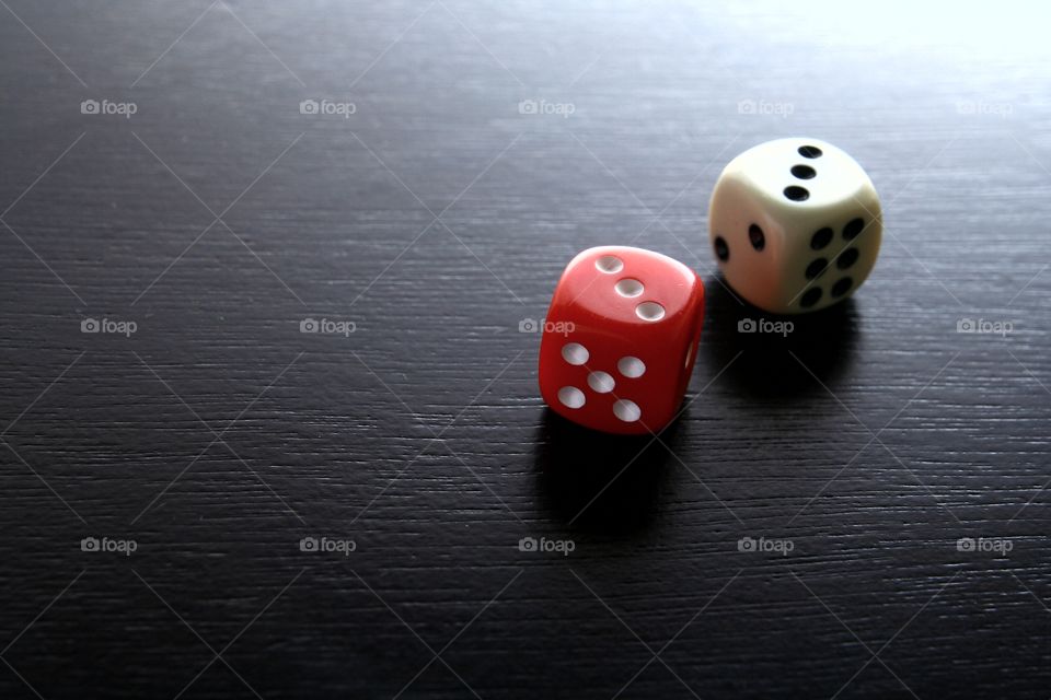 red and white game dice. photo of red and white game dice on a wooden table