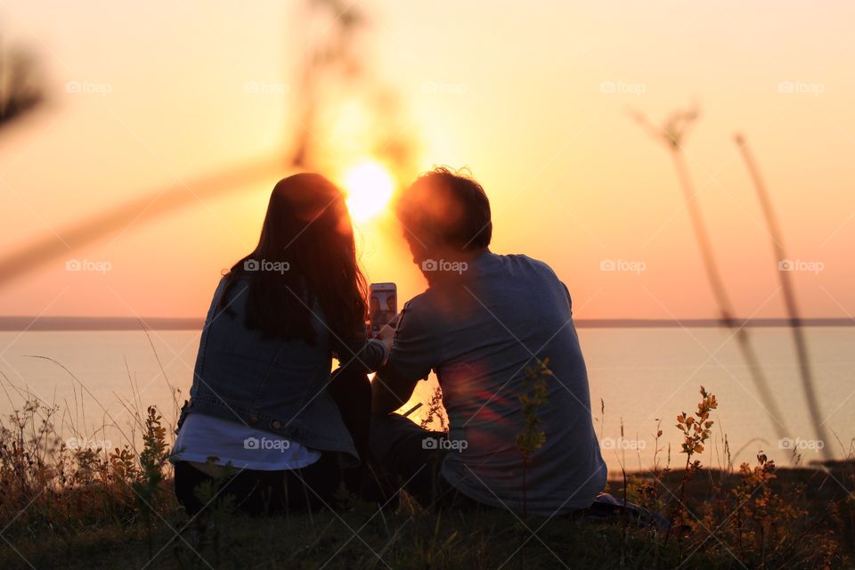 Loving couple watching sunset