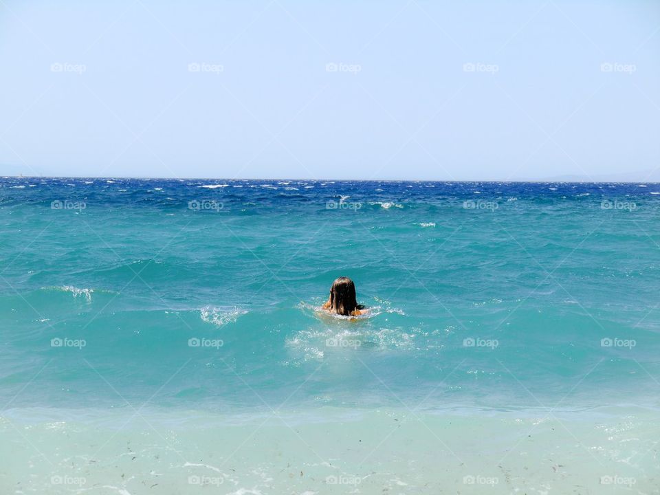 Blue ocean swimming. Swimming in clear blue water