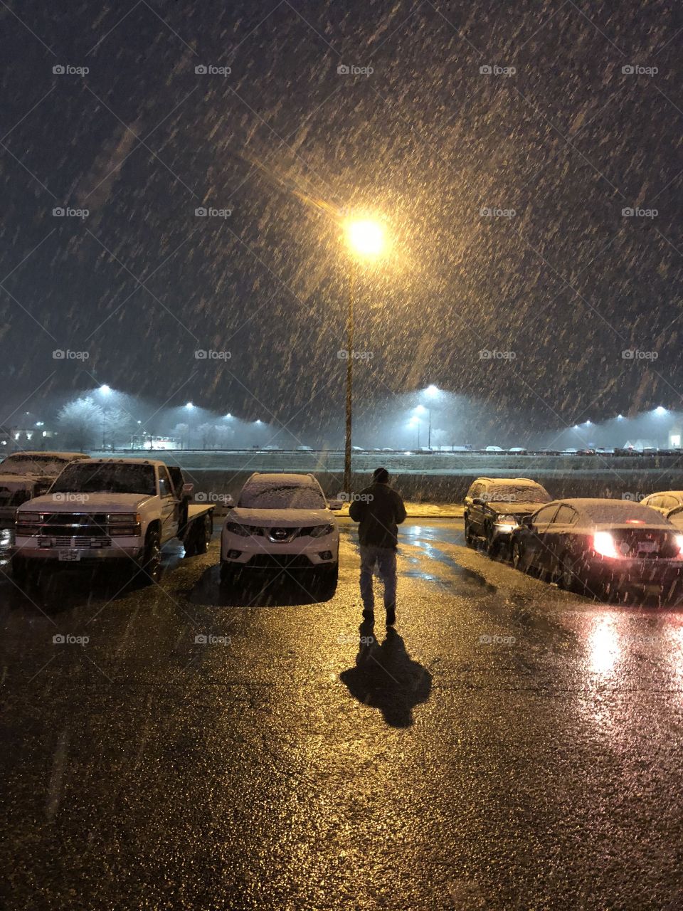 Parking lot at night during snowstorm 