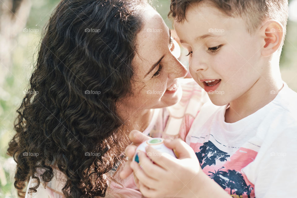 Happy boy and mom playing together and laughing 