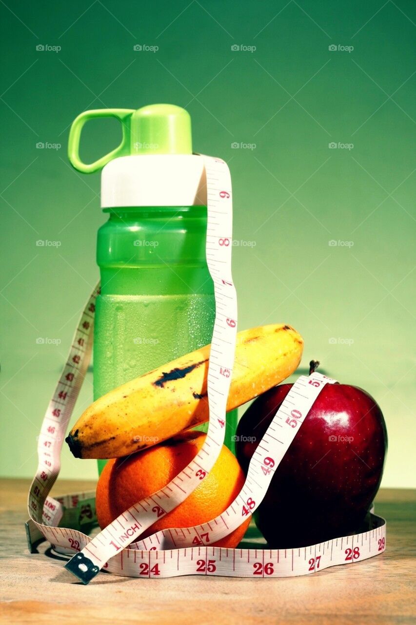 Water, fruits and tape measure