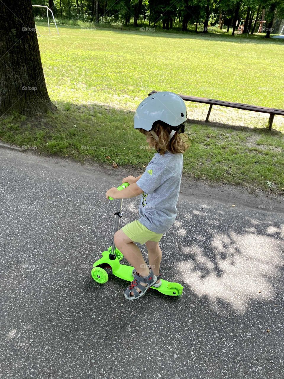 Little boy riding on a scooter