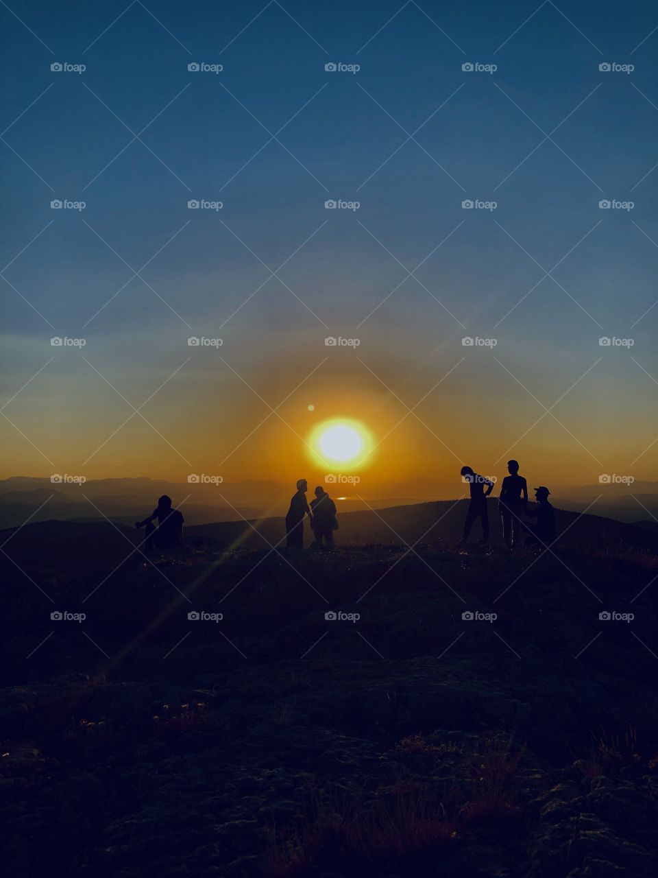 A family photo in a hiking trip who watching the sunset