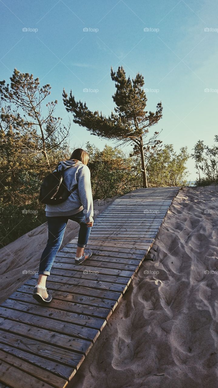 Sand dunes, ocean and my girl hiking. Really nice oldschool type photo.