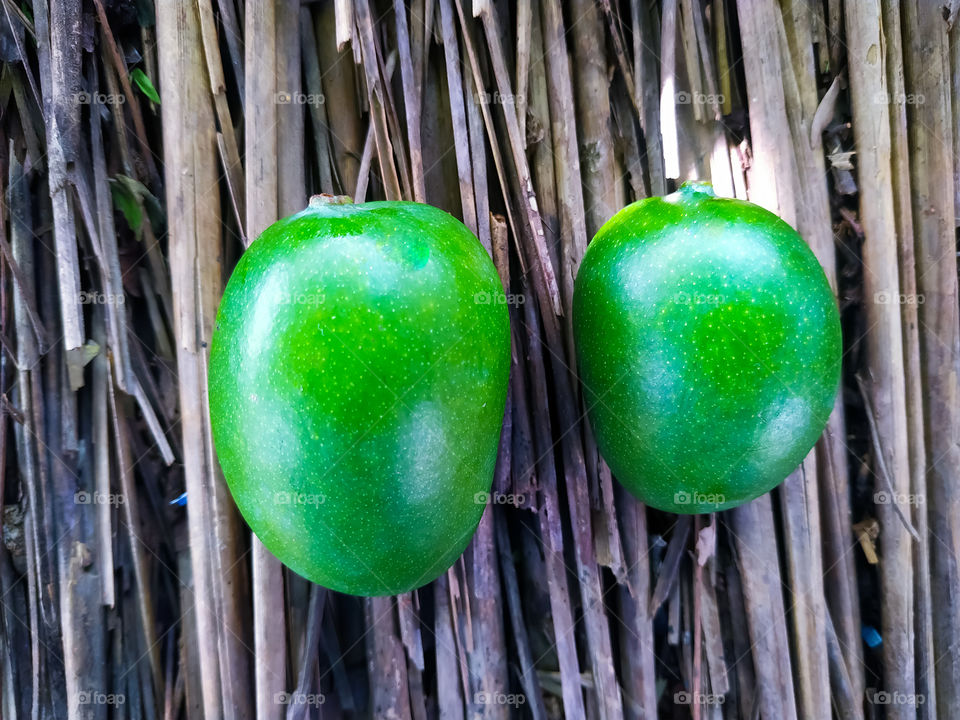 mango isolated on a rotted wood background