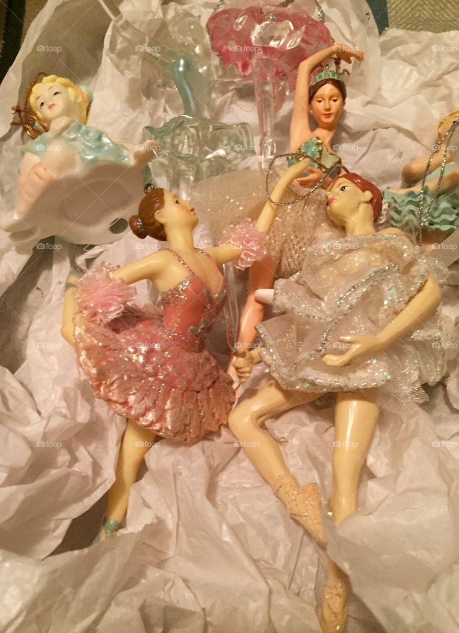 Collection of glass and porcelain ballerinas in various poses.
