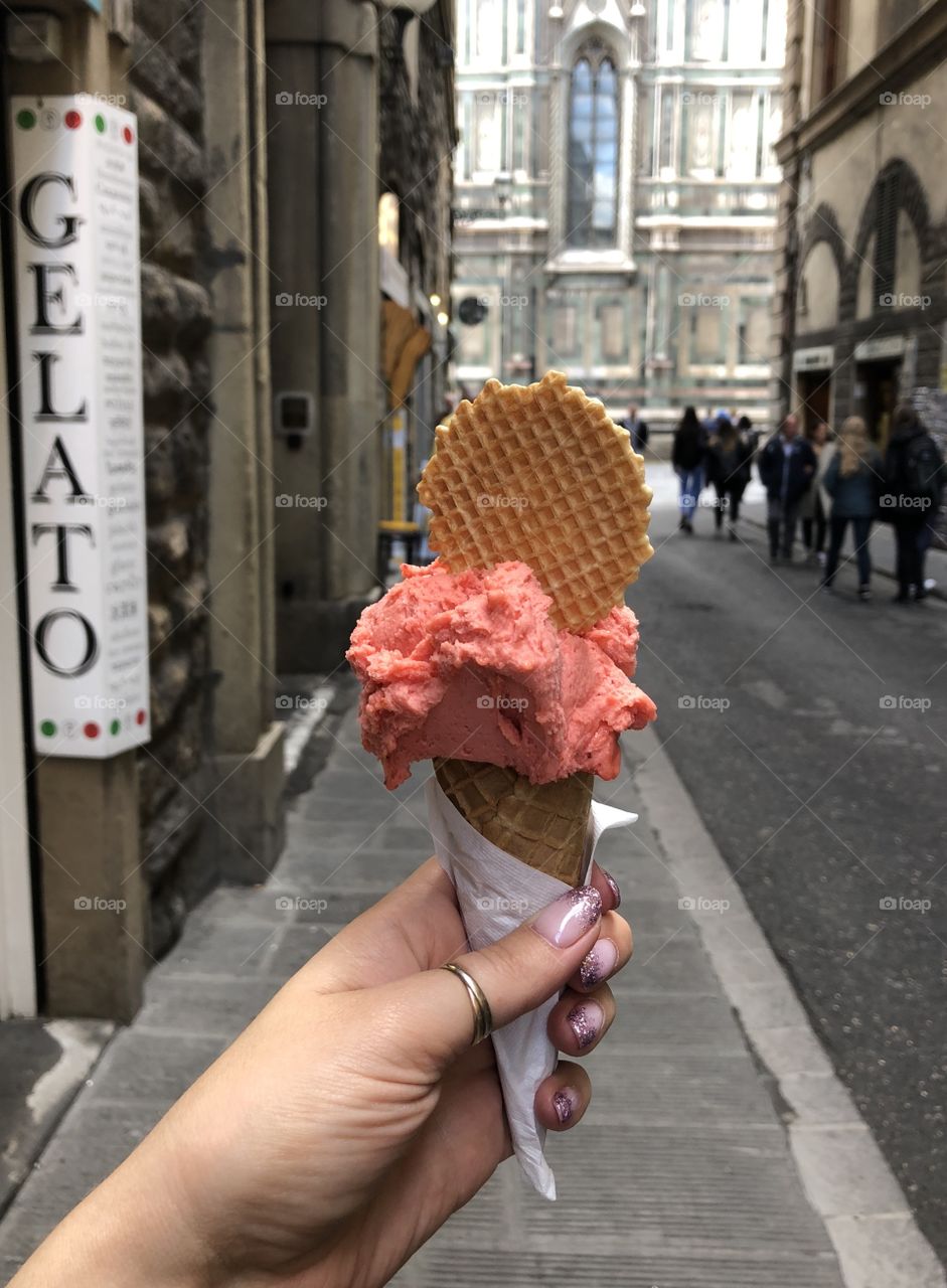 Gelato in female hand, Florence, Italy 