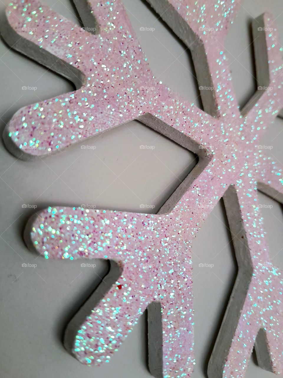 a nice pink snowflake in summer stuck to a wall.