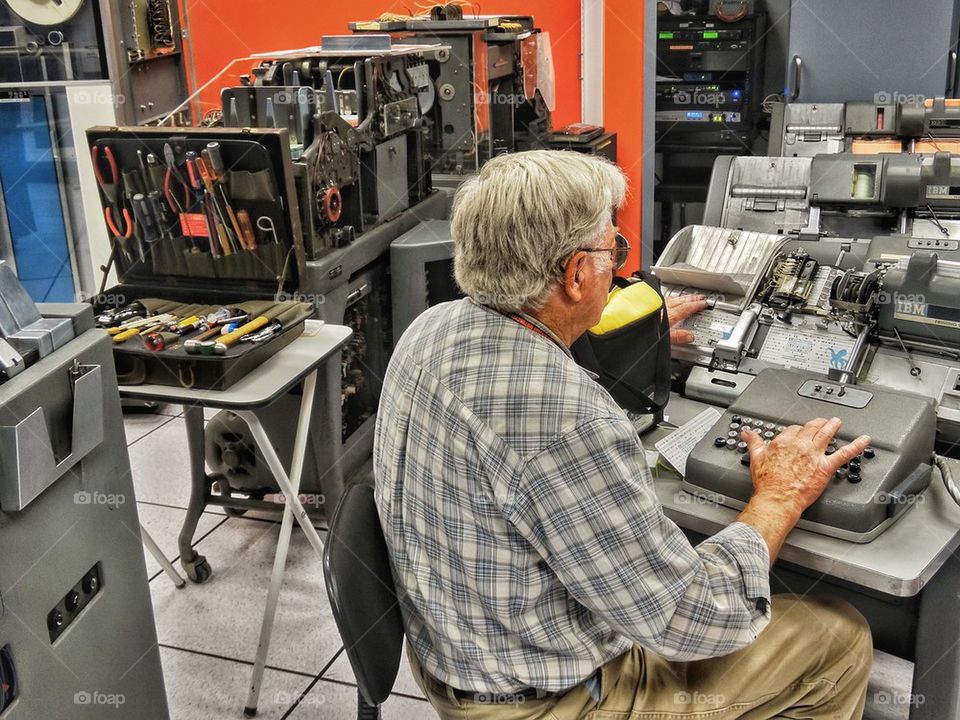 Technician operating 1950s era computer