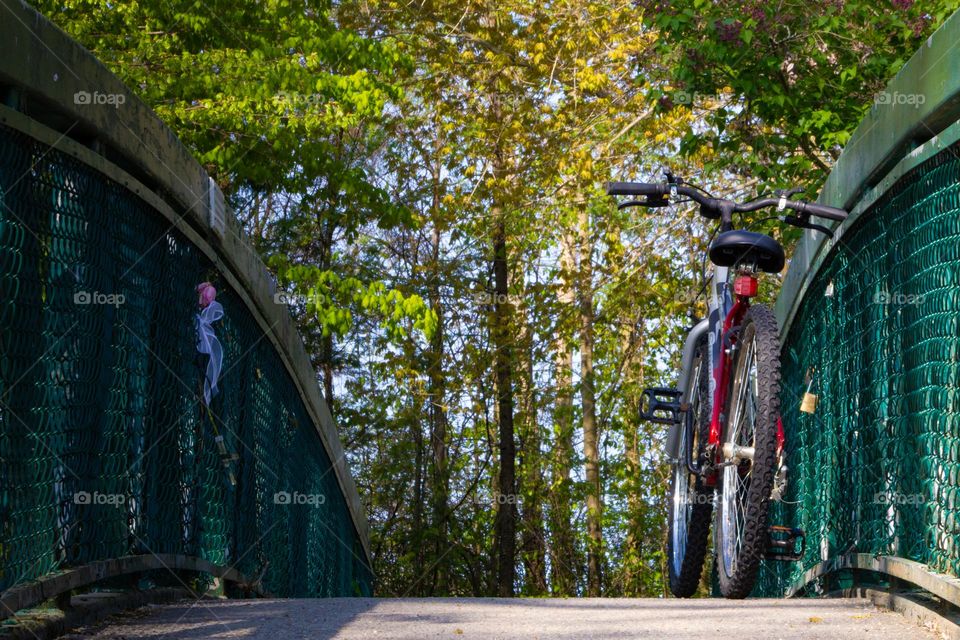 Lonely bicycle on a bridge in the morning sunlight.