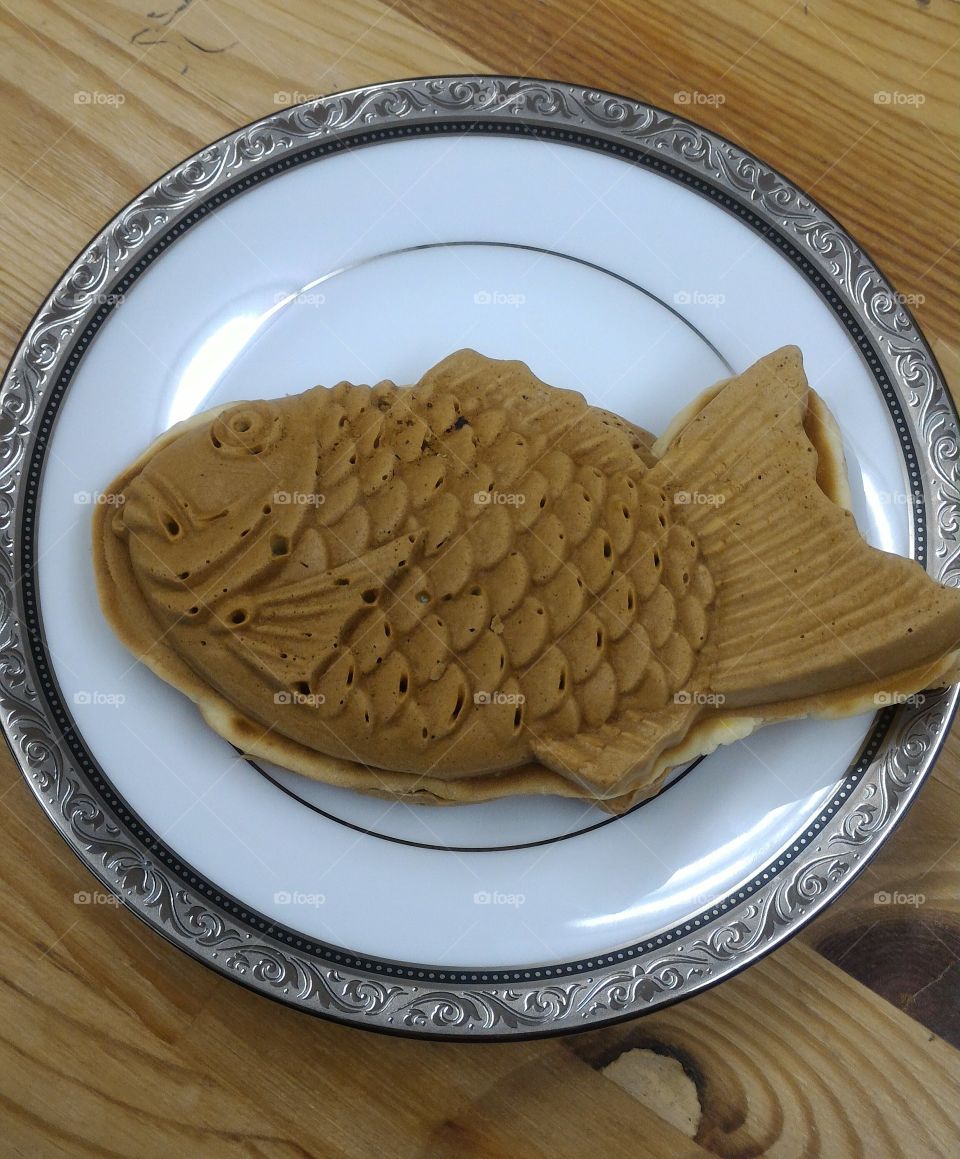 Japanese Taiyaki,  fish shaped sweet bean paste cake on a white dinner plate