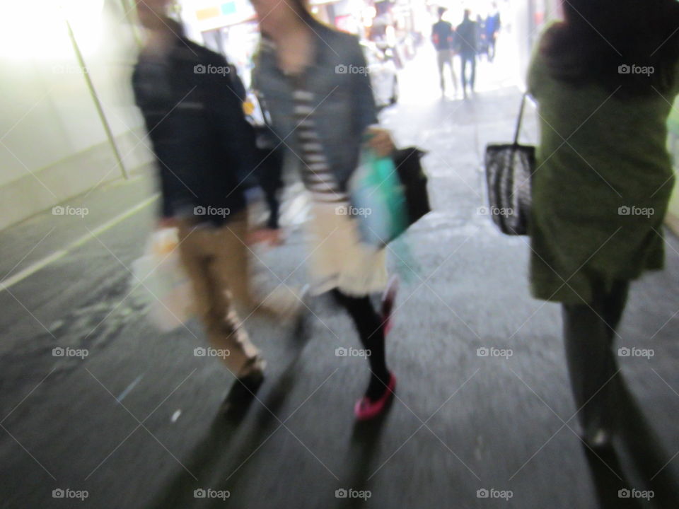 Young Japanese Couple, Holding Hands While Walking at Night.  Tokyo, Japan