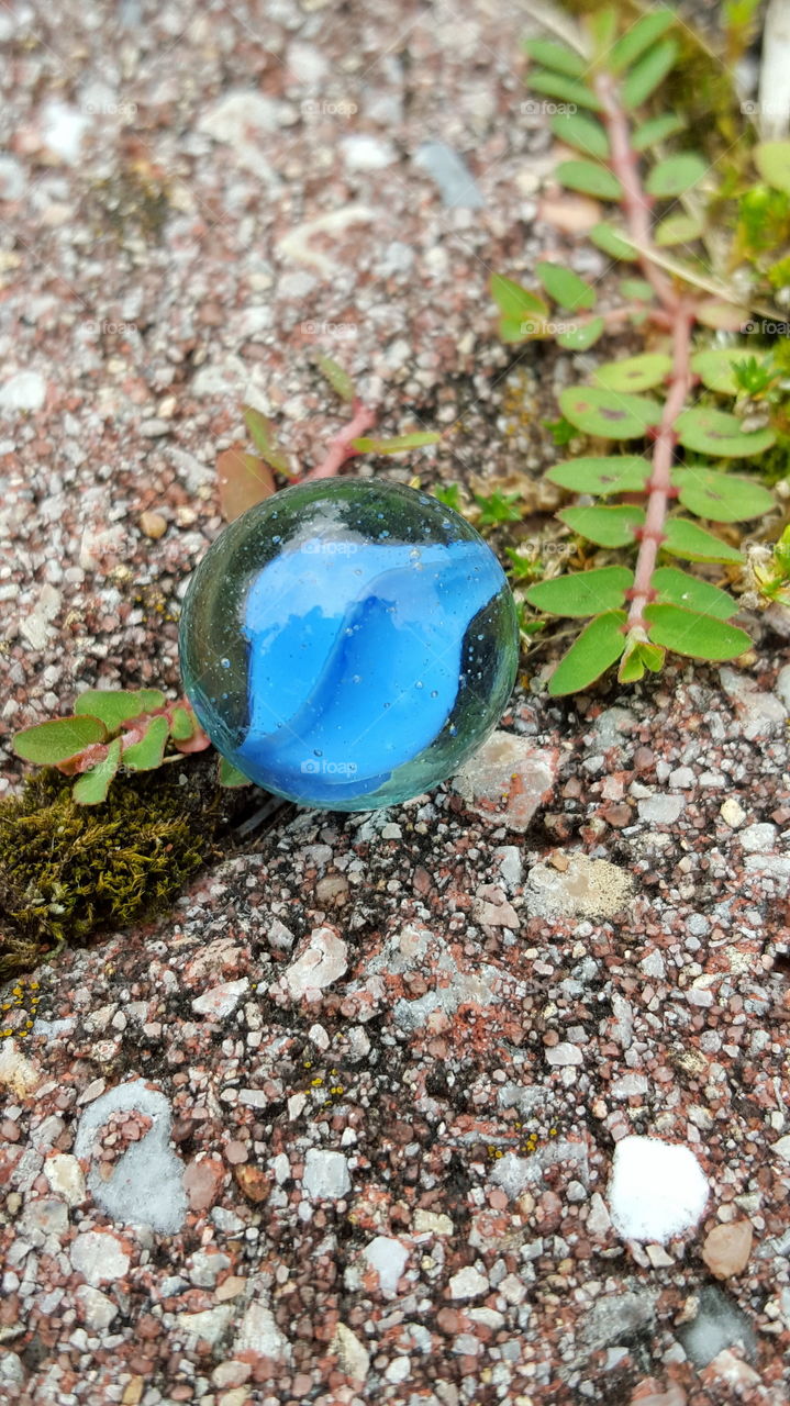 Glass cats eye marble. Swirling blue Cat's Eye glass marble close up