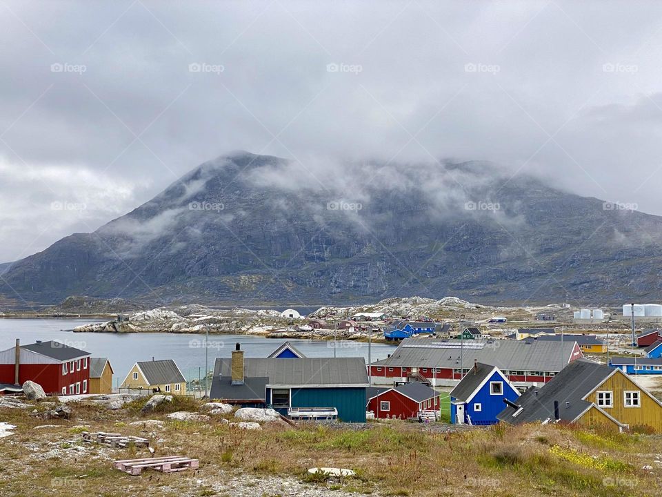 Brightly colored houses with a mountain in the background in Greenland 