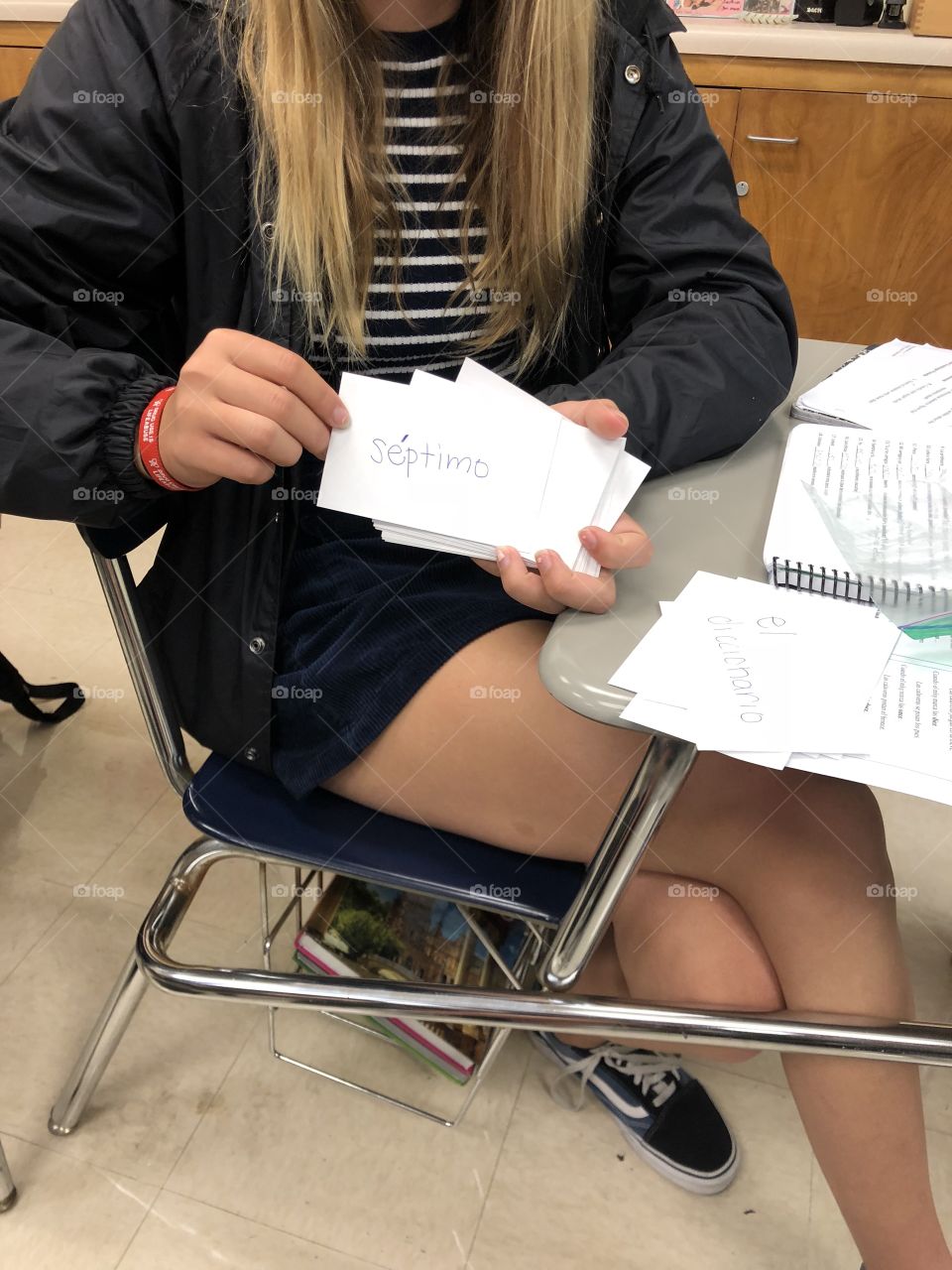 Female girl woman lady student studying cramming with vocabulary paper index card flash cards with study partner practicing for quiz test exam