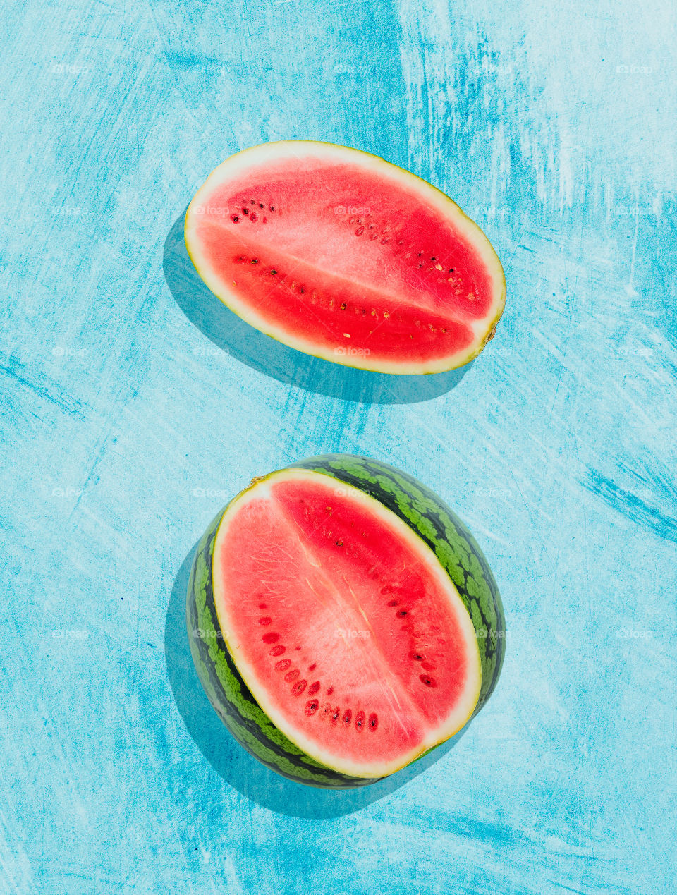 Pieces of watermelon on background painted in blue
