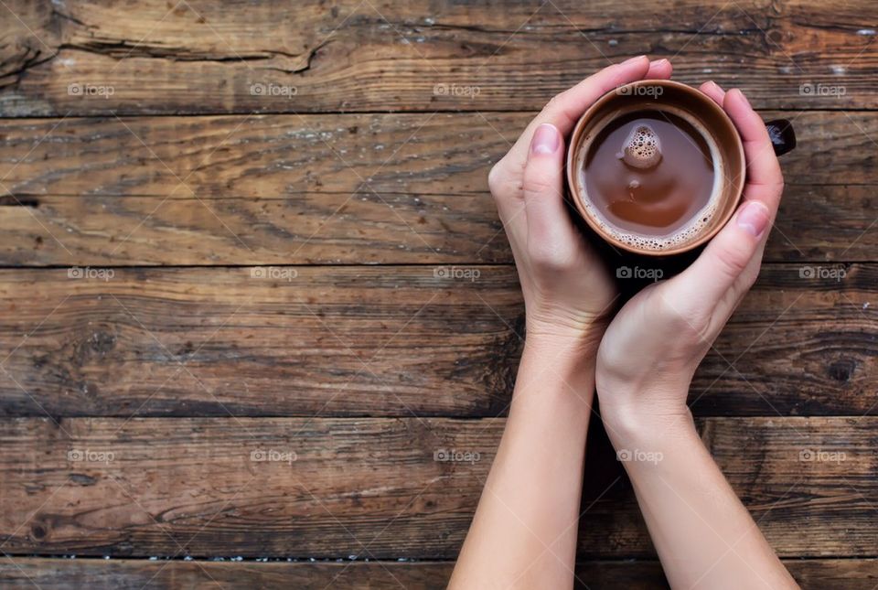 Close-up of woman's hand with chocolate drink