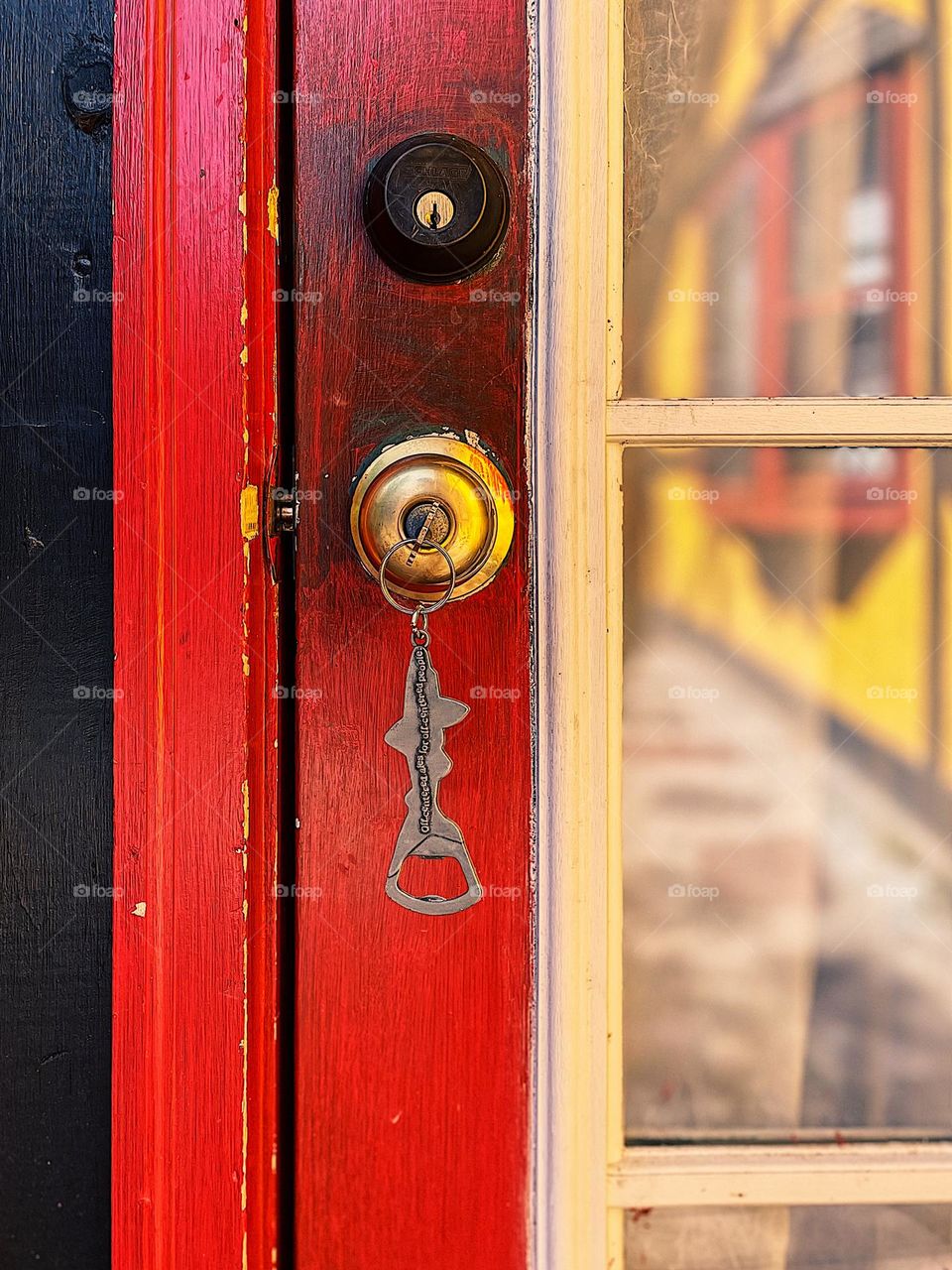 Door with key in the lock, reflections in the window panes of the door, front door to the AirBnB, entering a vacation home, traveling in New Hampshire