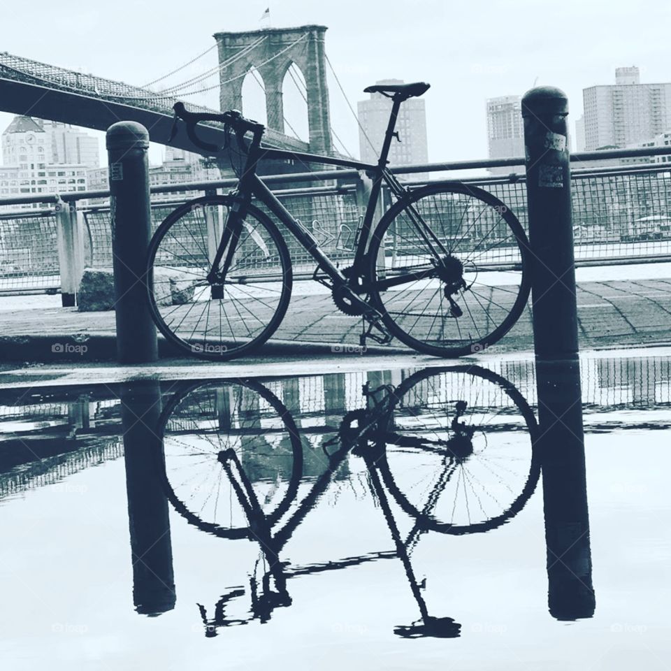 New York City by bicycle with the snow melting creating beautiful reflections 