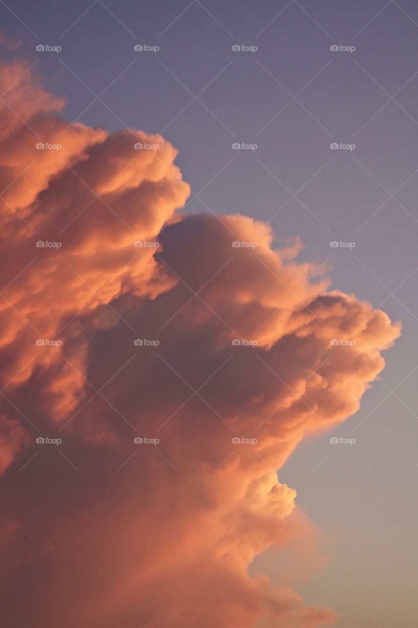Isolated view of a colorful, dramatic tower of cumulonimbus clouds