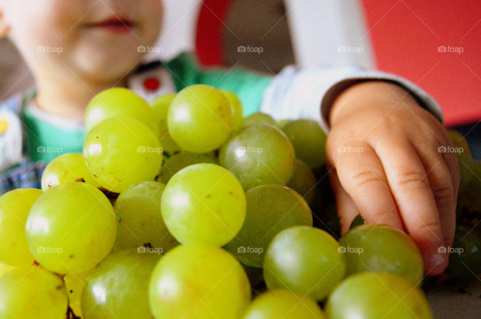 child eat grapes - macro shot