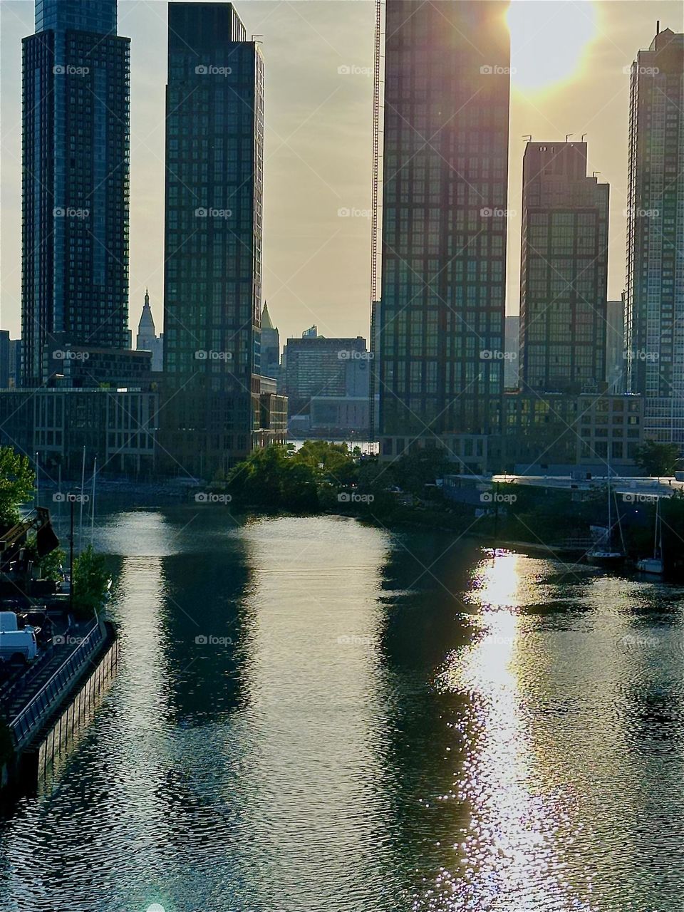 This is “Newtown Creek”, an ocean inlet of the “East River” seen from the “Pulaski Bridge” that connects “Greenpoint”, Brooklyn to LIC, Queens. Across the water in the distance we see parts of “Manhattan”. 2024. Hypnotic Productions