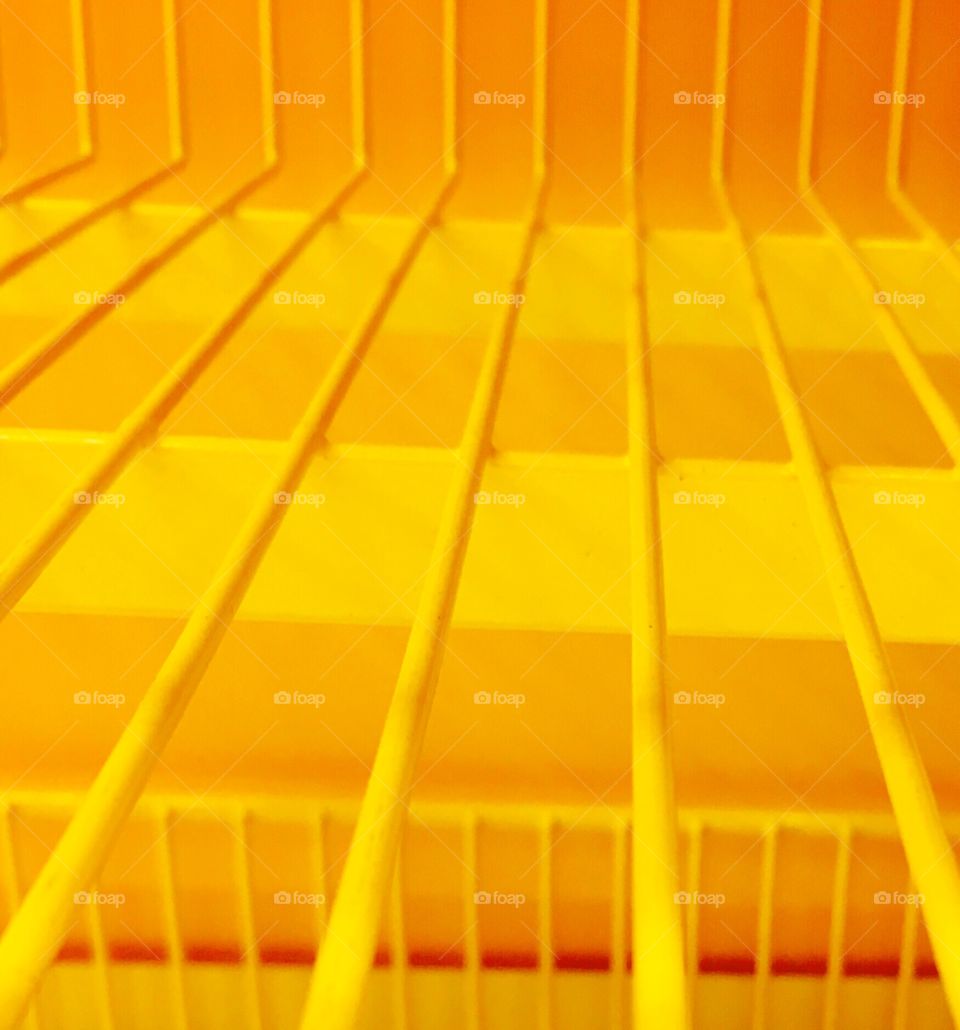 Empty yellow shelf in toy store.