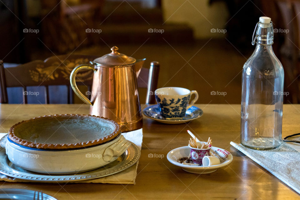 Delicious pie with objects on table