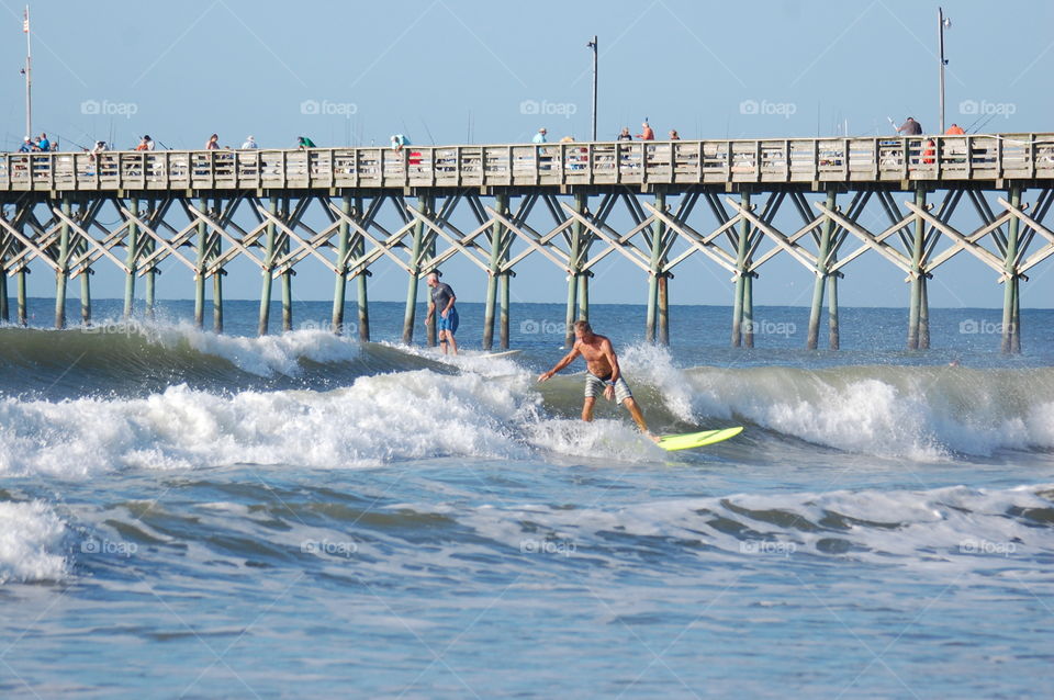Surfing by the pier