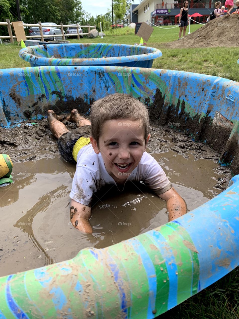 Boy plays in the mud