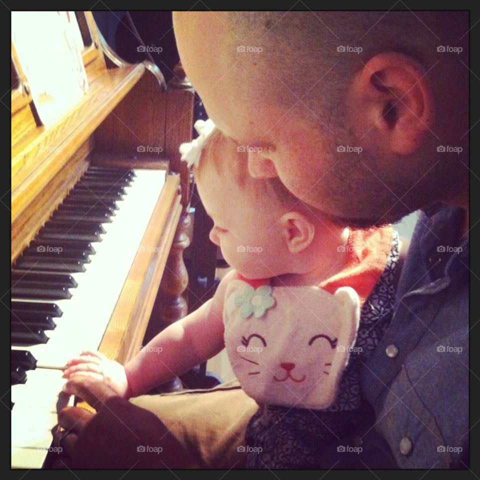 Father and baby playing piano