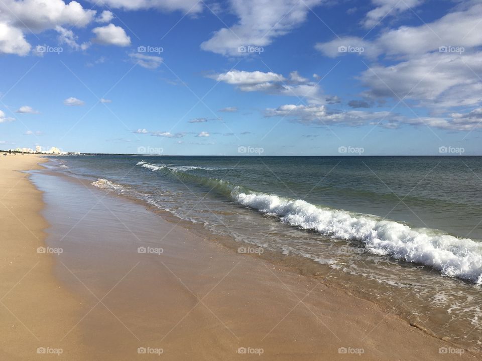 Sunny beach with gentle waves