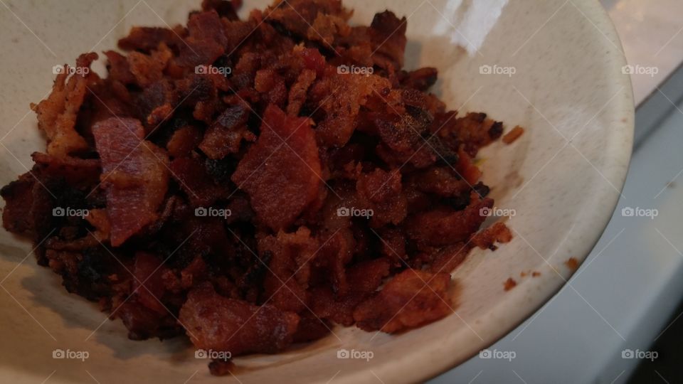 Small bowl of crumbed up crispy bacon for meatball soup