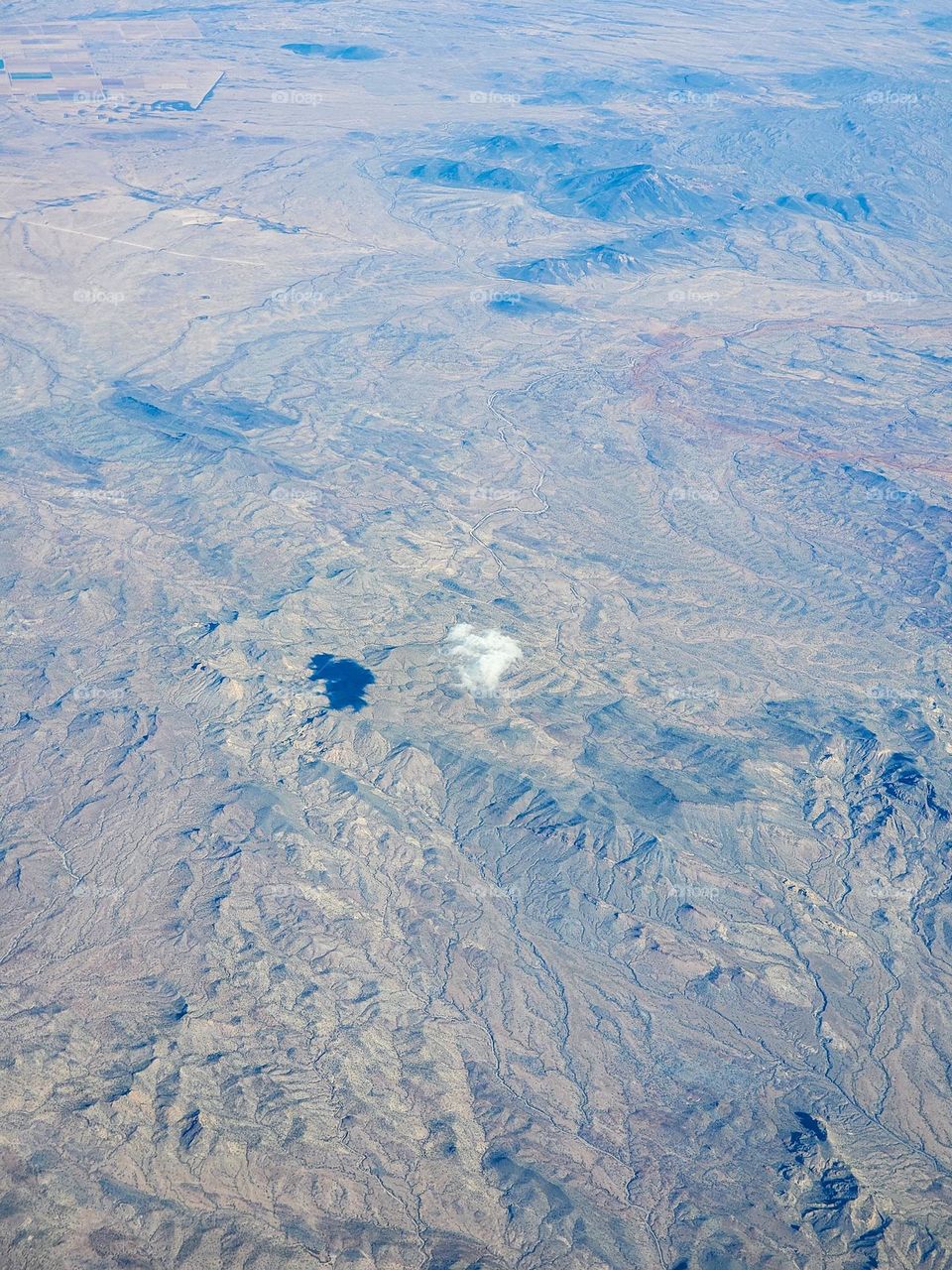 A small lone cloud floats over the arid Sonoran desert in Arizona